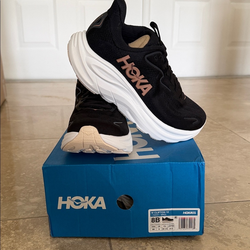 Brand new in box.  Size 8. Hoka Black and White Sneakers with Pink Accents